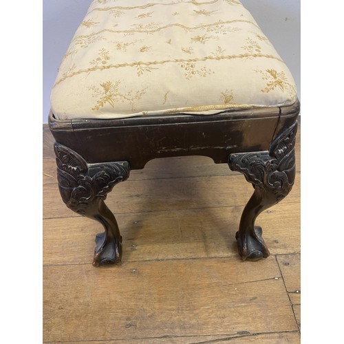 886 - A George III style footstool, raised on carved cabriole legs to ball and claw feet, 53 cm wide