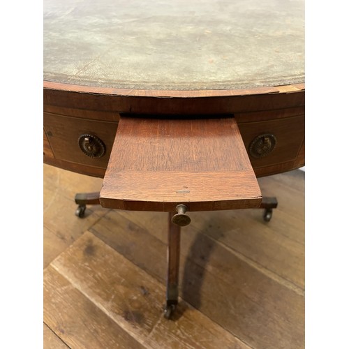 847 - A 19th century mahogany drum table, with a tooled and gilt leather inset top, having four frieze dra... 