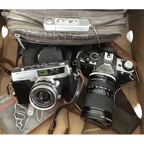 717 - A Canon AE-1 camera, an Olympus lens, a Minox spy type camera, and assorted other photography items ... 