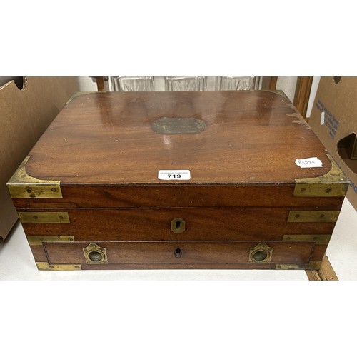 719 - A 19th century mahogany campaign box, bound in brass, with a key which fixes the box, by two 'screws... 