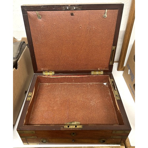 719 - A 19th century mahogany campaign box, bound in brass, with a key which fixes the box, by two 'screws... 