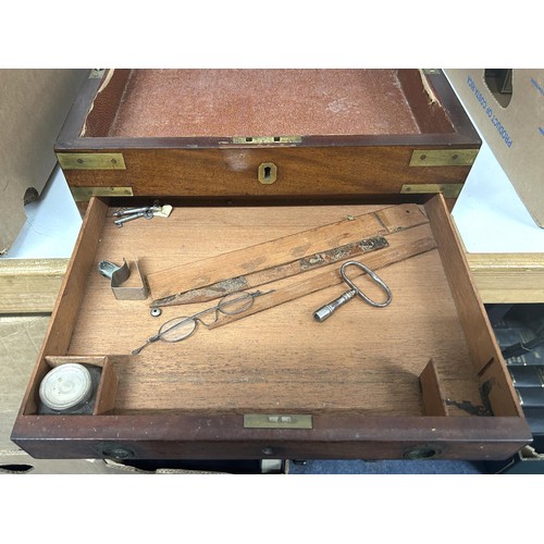 719 - A 19th century mahogany campaign box, bound in brass, with a key which fixes the box, by two 'screws... 