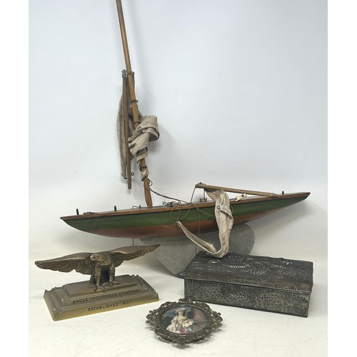 724 - An early 20th century pond yacht, a Chinese silver plated box, decorated dragon, and assorted metalw... 