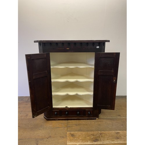 843 - An oak corner cabinet, with three drawers to the base, 94 cm wide