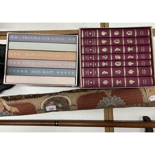 730 - A desk lamp, a bronze effect figure of two cranes, Folio Society books, walking sticks, and other it... 