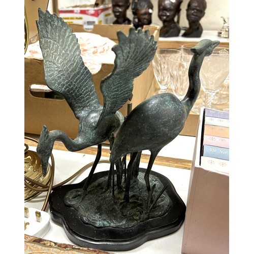 730 - A desk lamp, a bronze effect figure of two cranes, Folio Society books, walking sticks, and other it... 