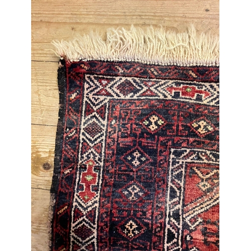 963 - A red ground rug, 190 x 112cm