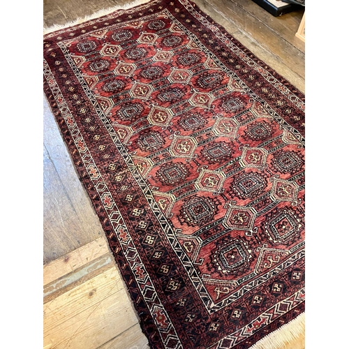 963 - A red ground rug, 190 x 112cm