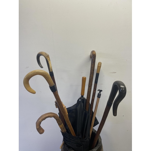 823 - A metal bound stick stand, and assorted walking sticks