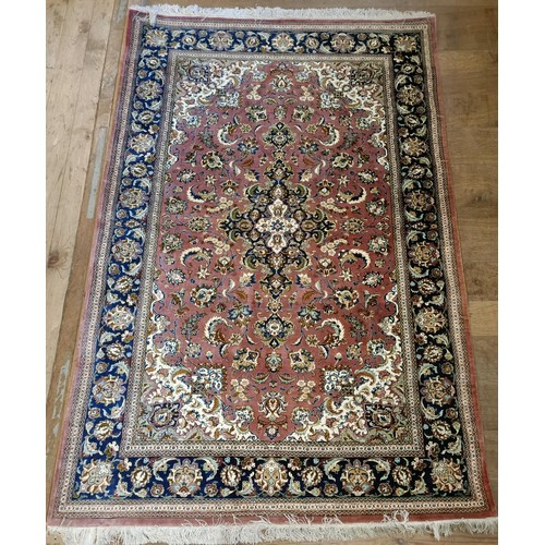 964 - A Persian Qum silk pink ground rug, 205 x 132 cm