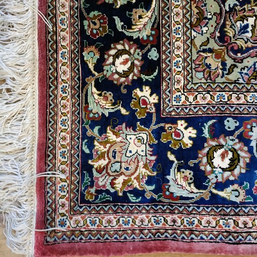 964 - A Persian Qum silk pink ground rug, 205 x 132 cm