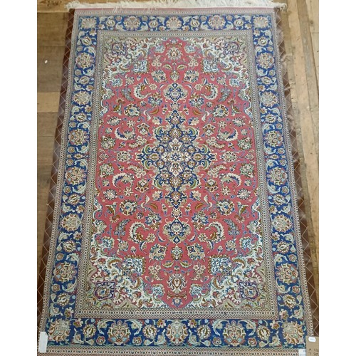 964 - A Persian Qum silk pink ground rug, 205 x 132 cm