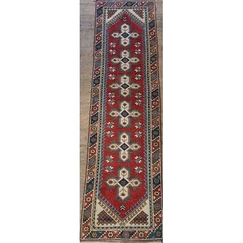 965 - A red ground runner, 275 x 75 cm, and a cream ground runner, 300 x 70 cm (2)