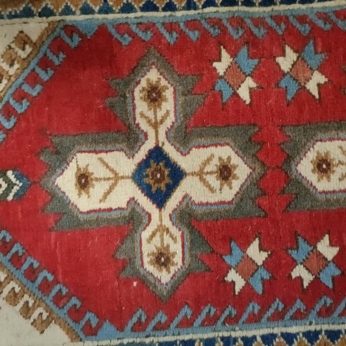 965 - A red ground runner, 275 x 75 cm, and a cream ground runner, 300 x 70 cm (2)