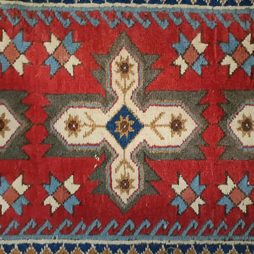 965 - A red ground runner, 275 x 75 cm, and a cream ground runner, 300 x 70 cm (2)