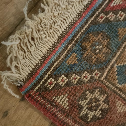 965 - A red ground runner, 275 x 75 cm, and a cream ground runner, 300 x 70 cm (2)