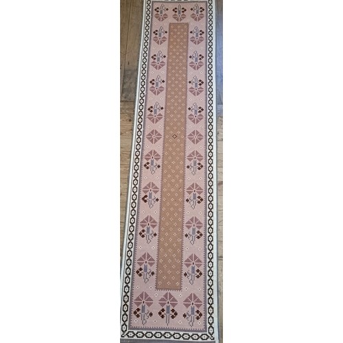 965 - A red ground runner, 275 x 75 cm, and a cream ground runner, 300 x 70 cm (2)