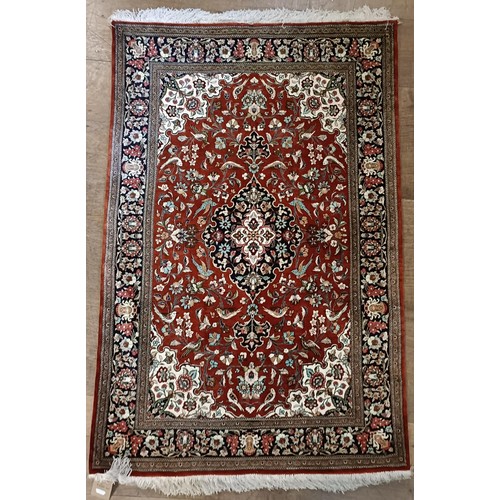 966 - A Persian Qum silk red ground rug, 150 x 100 cm