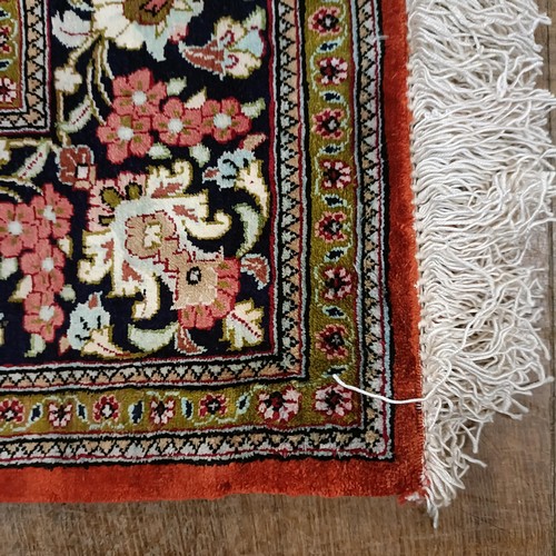 966 - A Persian Qum silk red ground rug, 150 x 100 cm