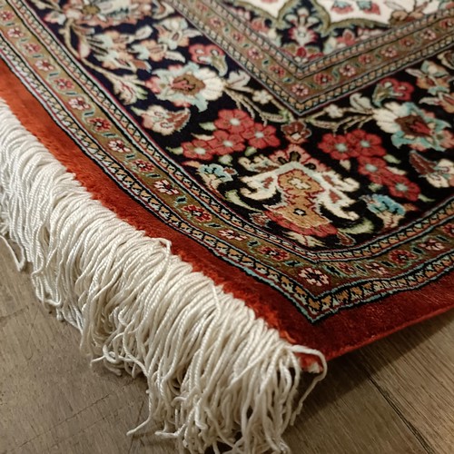 966 - A Persian Qum silk red ground rug, 150 x 100 cm