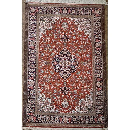 966 - A Persian Qum silk red ground rug, 150 x 100 cm