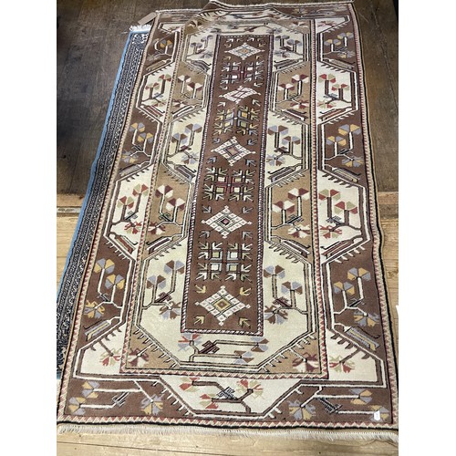 962 - A red ground rug, 105 x 80 cm, a cream ground rug, 150 x 95 cm, a cream ground rug, 225 x 125 cm, a ... 