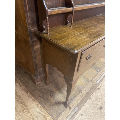 898 - An oak dresser, having a three tier plate rack, on a base with three drawers, on cabriole legs to pa... 