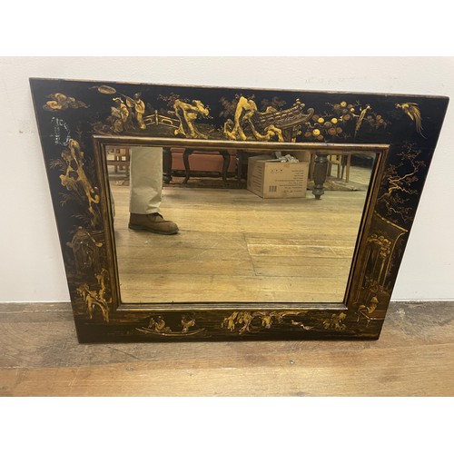 887 - A wall mirror, with a lacquered frame in the Chinese manner, 80 x 60 cm