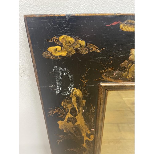 887 - A wall mirror, with a lacquered frame in the Chinese manner, 80 x 60 cm