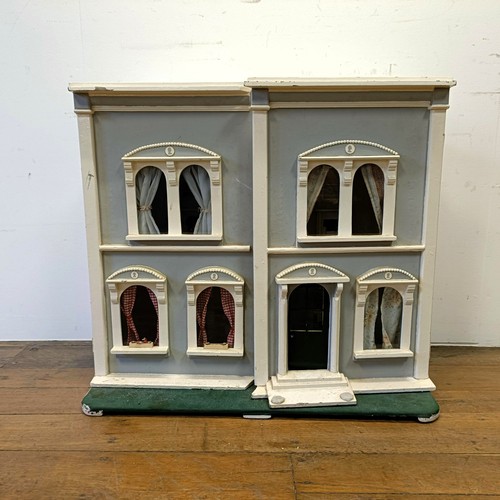 734 - A painted dolls house, 73 cm high x 81 cm wide