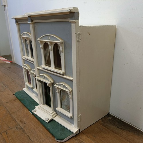 734 - A painted dolls house, 73 cm high x 81 cm wide