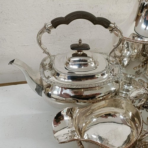 582 - A silver plated hot water jug, a pair of silver plated bottle coasters, a kettle on stand, and assor... 