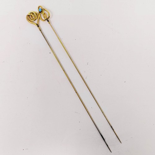 1437 - A pair of yellow coloured metal, turquoise and gilt metal hairpins (2)