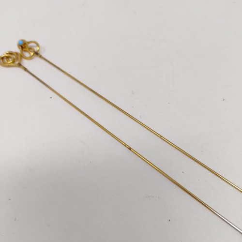 1437 - A pair of yellow coloured metal, turquoise and gilt metal hairpins (2)