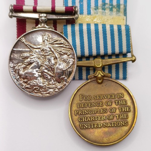 704 - A pair of medals, awarded to P/JX 919975 A B Smith AB RN, comprising a Naval General Service Medal, ... 