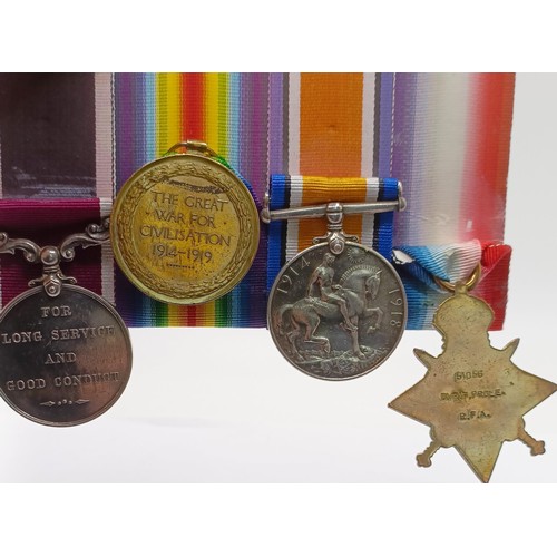 735 - A group of four medals, awarded to 51056 Dvr F Prole RFA, comprising a 1914 Star Trio (worn with pri... 