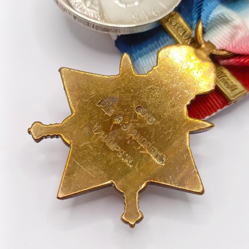 765 - A group of four medals, awarded 6913 Pte A J Andrews 1/Hamps R, comprising a 1914-15 Star Trio, with... 