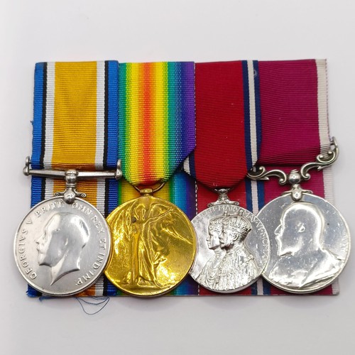 820 - A group of four medals, awarded to 724 Pte T L Kemble C Gds, comprising a British War Medal and Vict... 