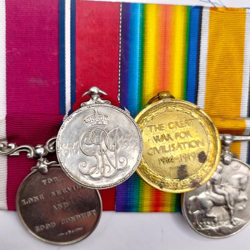 820 - A group of four medals, awarded to 724 Pte T L Kemble C Gds, comprising a British War Medal and Vict... 