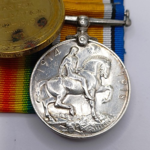 820 - A group of four medals, awarded to 724 Pte T L Kemble C Gds, comprising a British War Medal and Vict... 