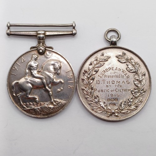 832 - A British War Medal, awarded to 268 Gnr D Thomas RA, and a silver medallion In Defence European War ... 