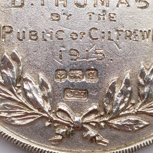 832 - A British War Medal, awarded to 268 Gnr D Thomas RA, and a silver medallion In Defence European War ... 