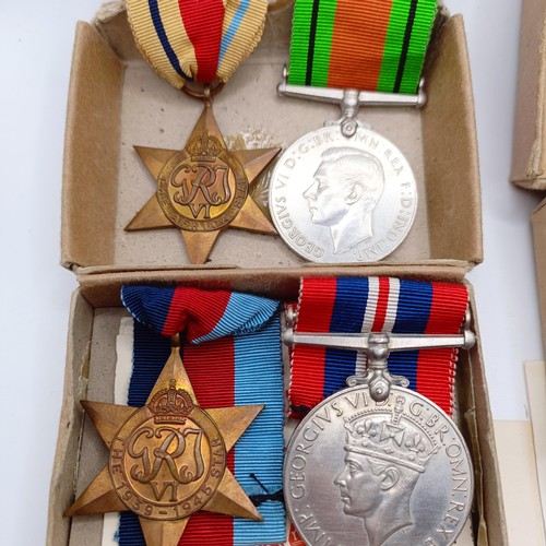 920 - Two groups of WWII medals in boxes of issue, addressed to Mr E C Hewitt and Mr J F Hewitt, a small s... 