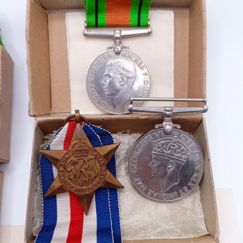 920 - Two groups of WWII medals in boxes of issue, addressed to Mr E C Hewitt and Mr J F Hewitt, a small s... 