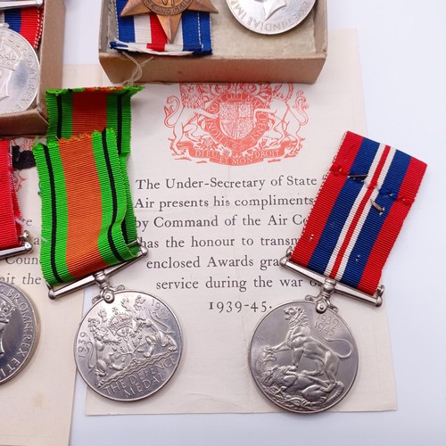 920 - Two groups of WWII medals in boxes of issue, addressed to Mr E C Hewitt and Mr J F Hewitt, a small s... 