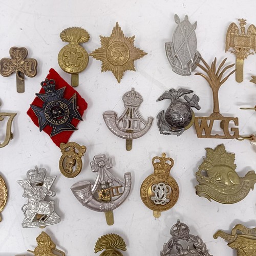 981 - Assorted military cap and other badges