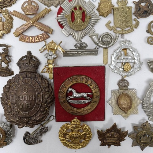 987 - Assorted military cap and other badges