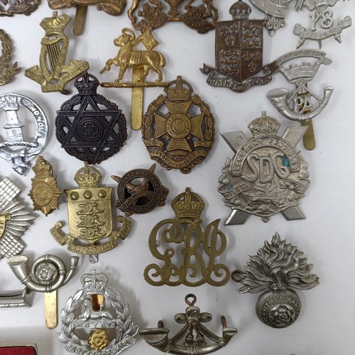 987 - Assorted military cap and other badges