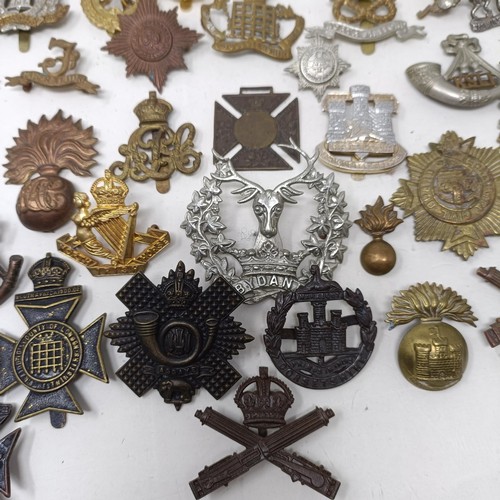 989 - Assorted military cap and other badges