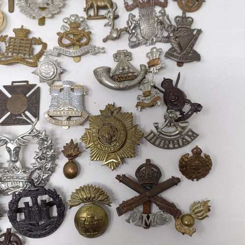 989 - Assorted military cap and other badges